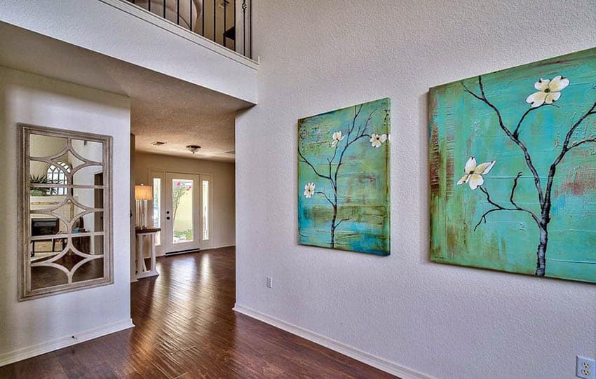 Hallway with bright green paintings artwork