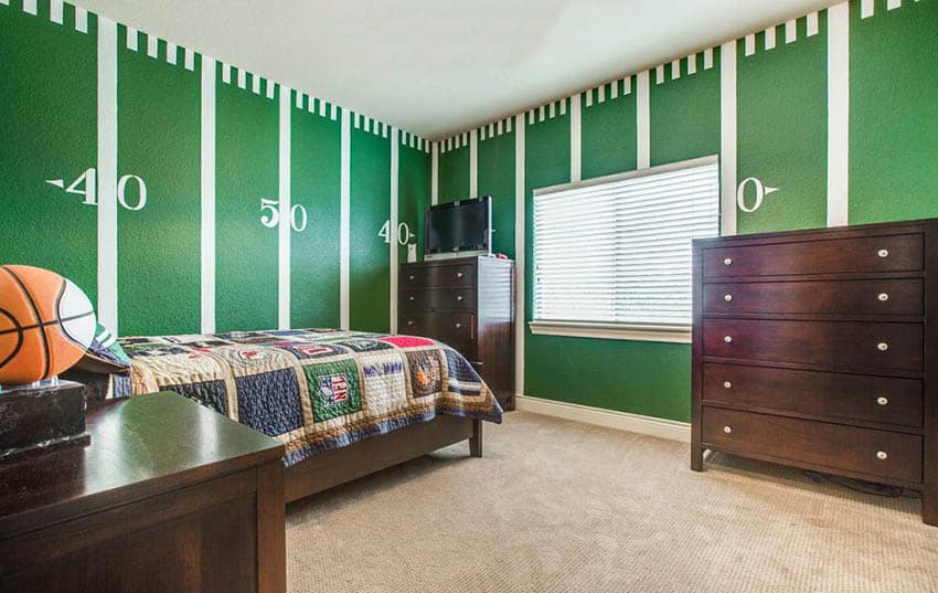 Kids bedroom with green football field painted wall