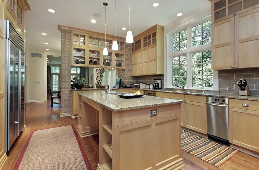 Kitchen with unfinished wood cabinets wood floors and light color granite countertops
