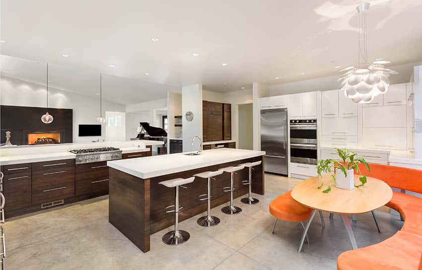 Luxury kitchen with brown & white cabinets, white counters and orange dining table bench