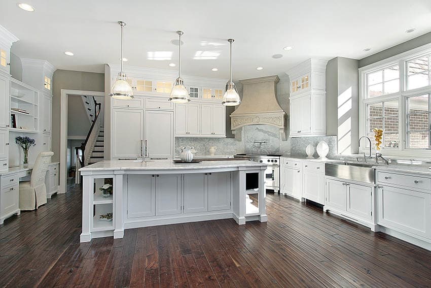 Kitchen with white cabinets, wide plank hand scraped wood flooring and white marble countertops