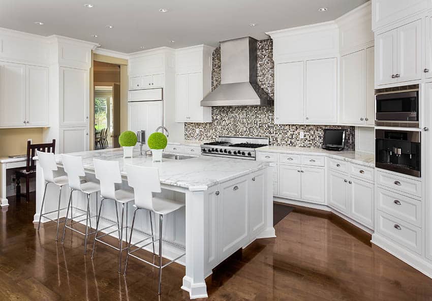 Kitchen with mosaic tile backsplash, large island and wood flooring