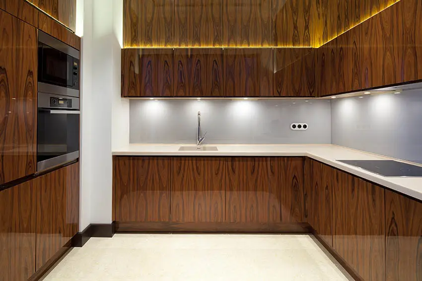 Kitchen with dark veneer cabinets and under cabinet lighting
