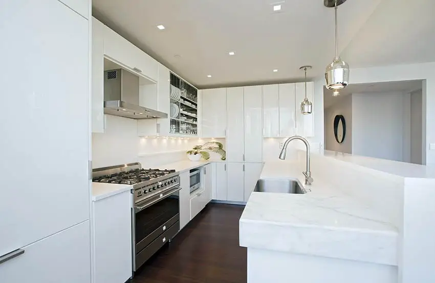All white kitchen with breakfast countertop and faucet