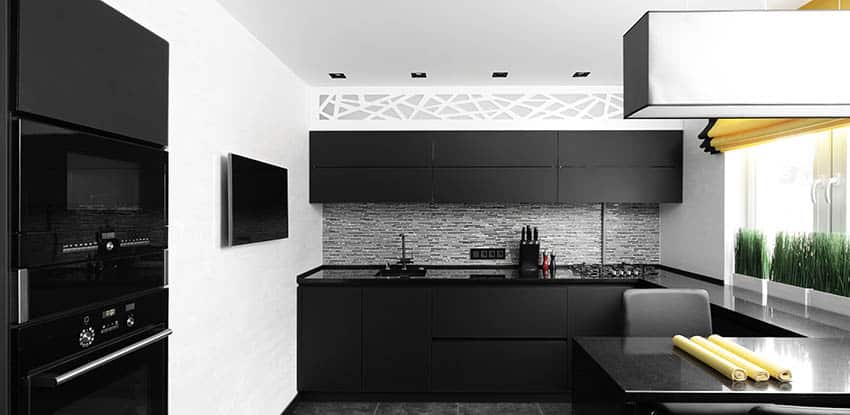 Small J-shaped kitchen with black cabinets