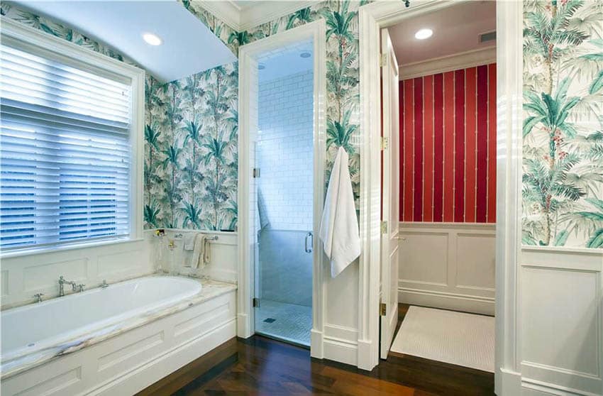 Bathroom with tropical wallpaper, carrara marble alcove bathtub and window blinds