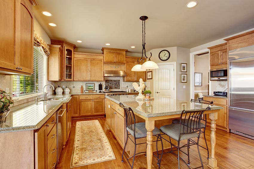 Traditional kitchen with oak cabinets wood floors and green granite countertops