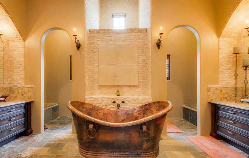 Traditional orange bathroom with copper tub and dual vanities