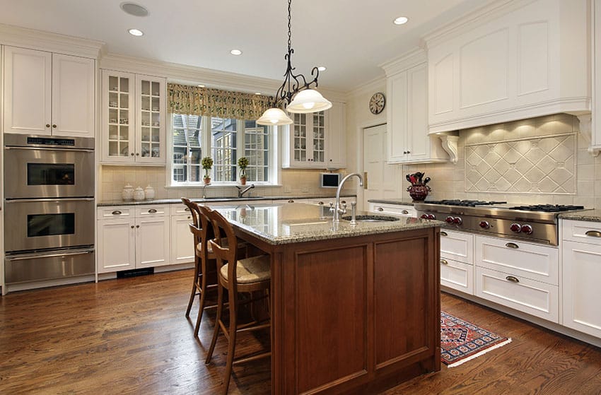 White country cabinet kitchen with wood island and wood flooring