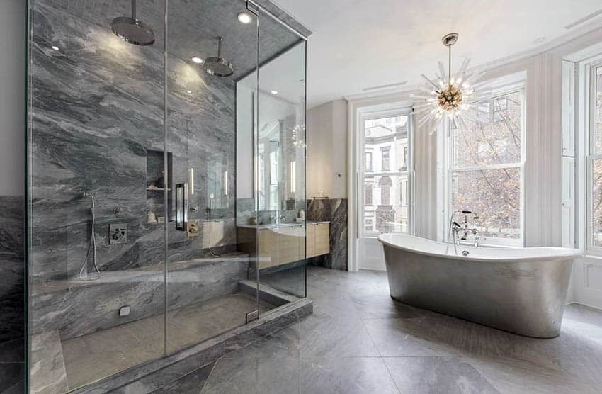 Contemporary bathroom with infinity shower drain and freestanding tub with chandelier