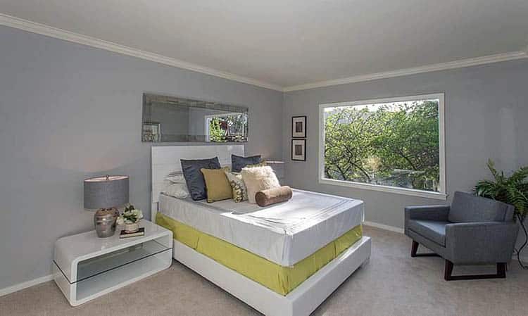 Contemporary bedroom with gray painted walls and contrasting yellow bottom bed sheet