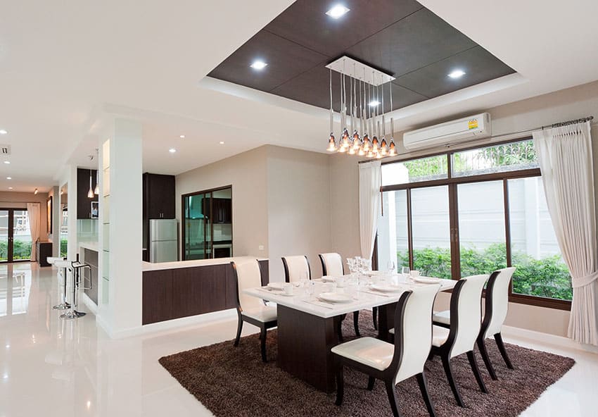 Room with cluster lighting, brown carpet and white polished floors