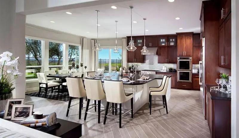 contemporary-kitchen-with-brown-cabinets-white-island-and-black-granite-countertops