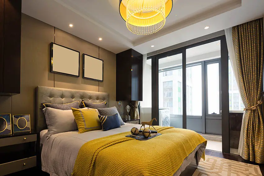 Contemporary yellow and gray bedroom design with round chandelier
