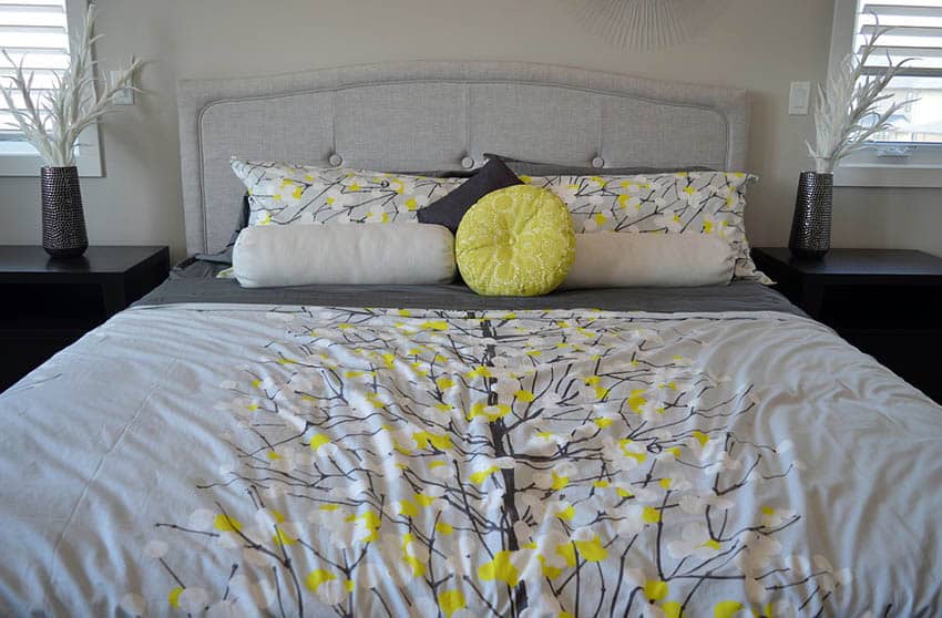 Gray bed with gray and yellow comforter