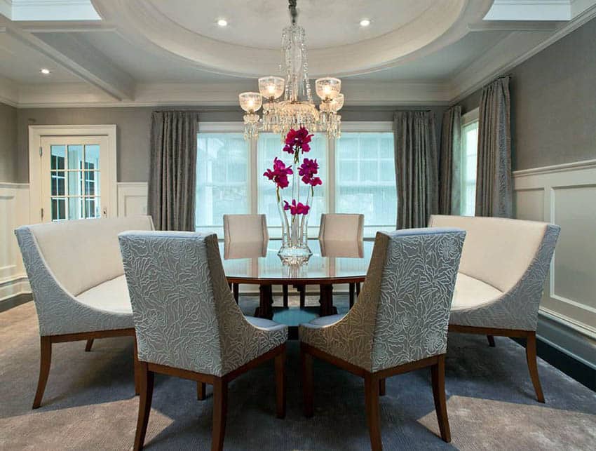 Gray dining room with chandelier and recessed lights