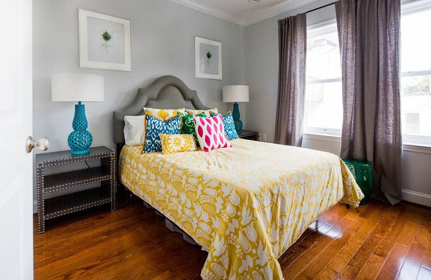 Light gray bedroom with gray bed and yellow comforter