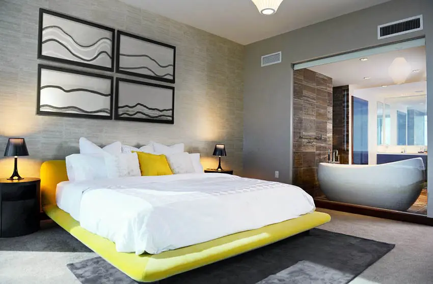 Modern bedroom with yellow platform bed and gray area rug