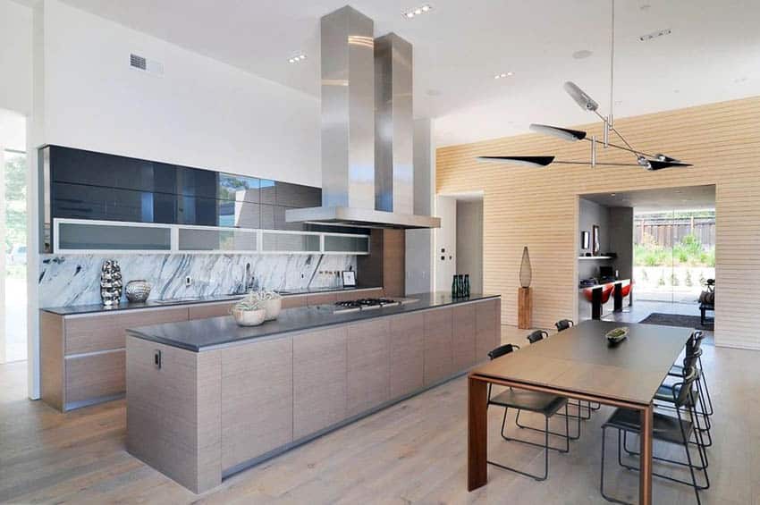 modern kitchen with gray quartz countertops marble backsplash and wood floors