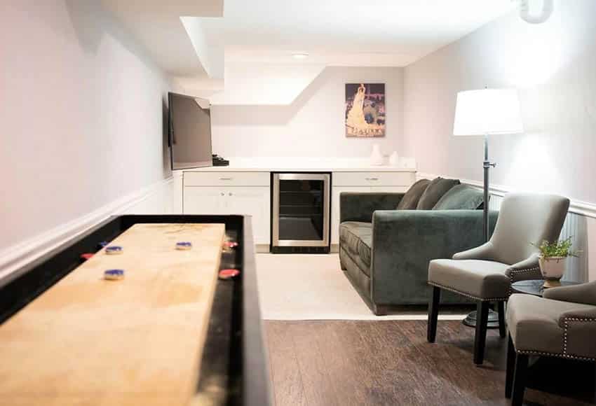 small-man-cave-with-home-bar-couch-and-shuffleboard-table