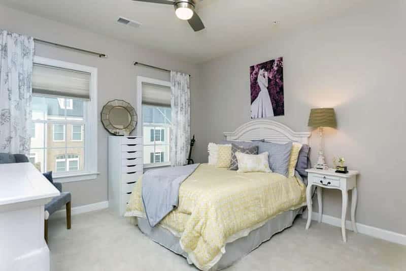 Traditional gray bedroom with yellow comforter and pillows