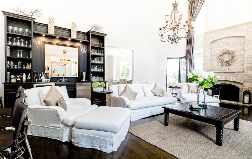 Cozy room with cabinet bar white furniture, chandelier, and fireplace