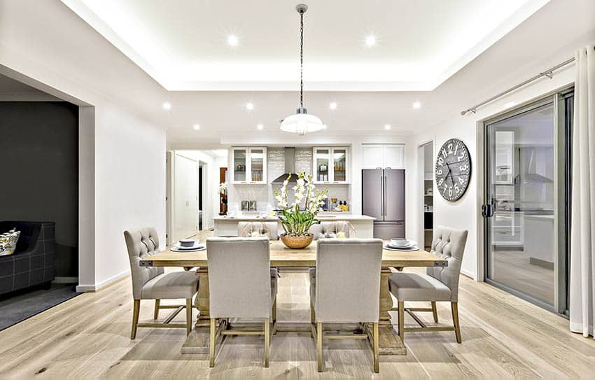 Transitional dining room and kitchen with round glass semi circle pendant light