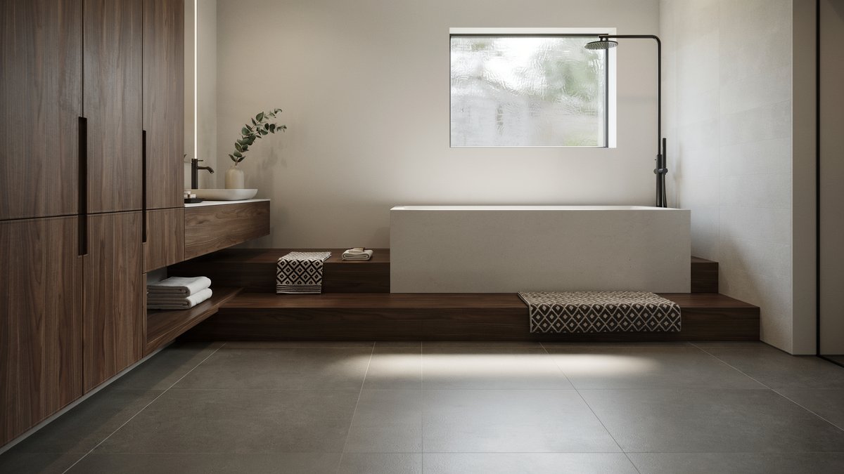 Gray, black and white bathroom with a platform tub framed for seating