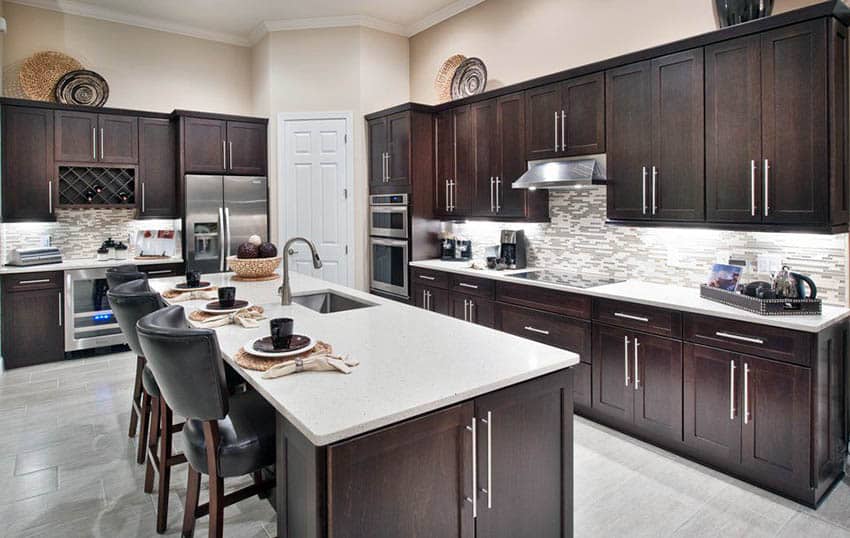 Contemporary kitchen with dark wood shaker style cabinets and ivory color paint