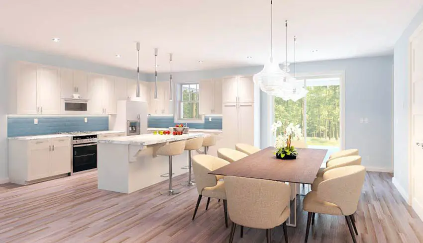 Kitchen with beige dining chairs, blue backsplash and wood board floors