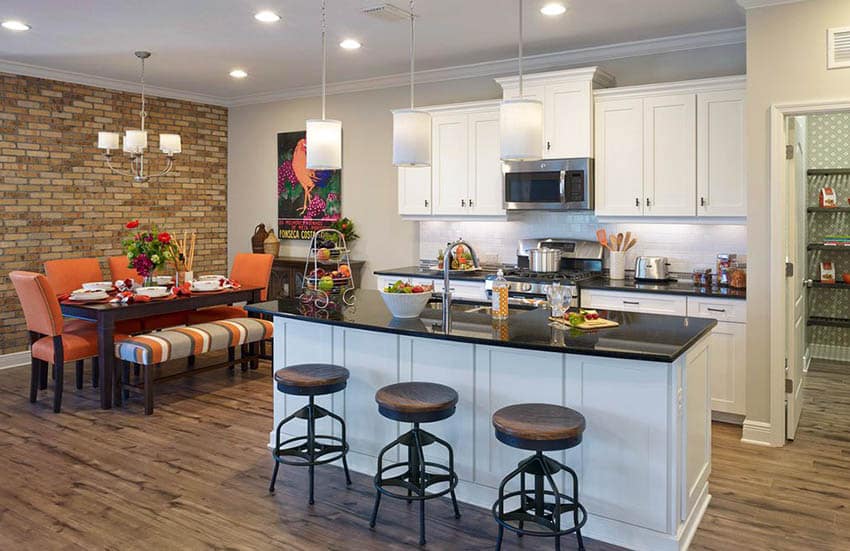 Kitchen with white cabinets, light gray painted walls and black granite