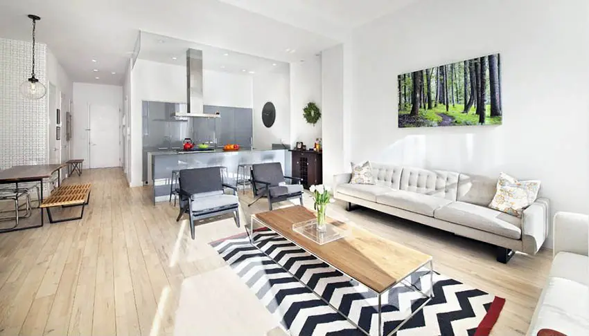 Contemporary living room with light wood flooring dining table
