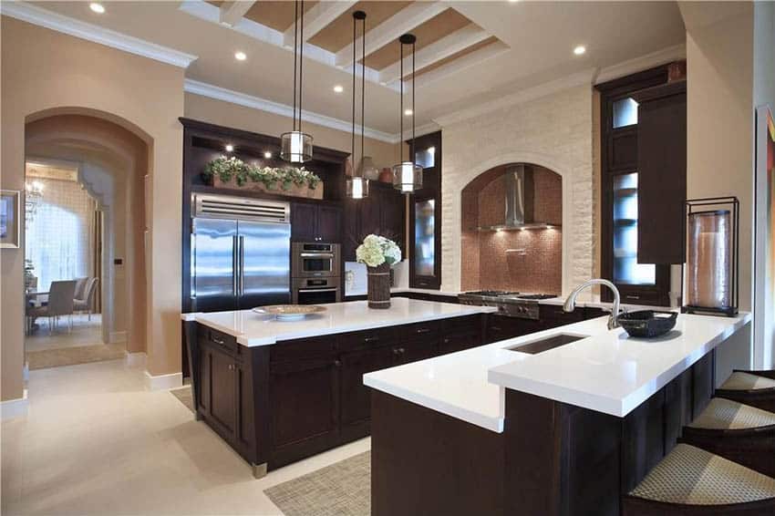 Large kitchen with dark cabinets, two islands and mocha paint
