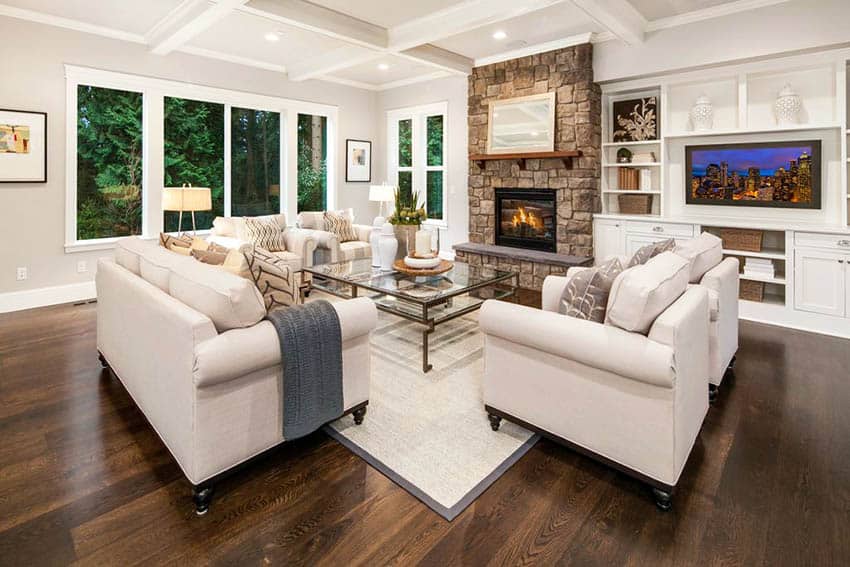 Living room with dark hardwood flooring, stone fireplace and box ceiling