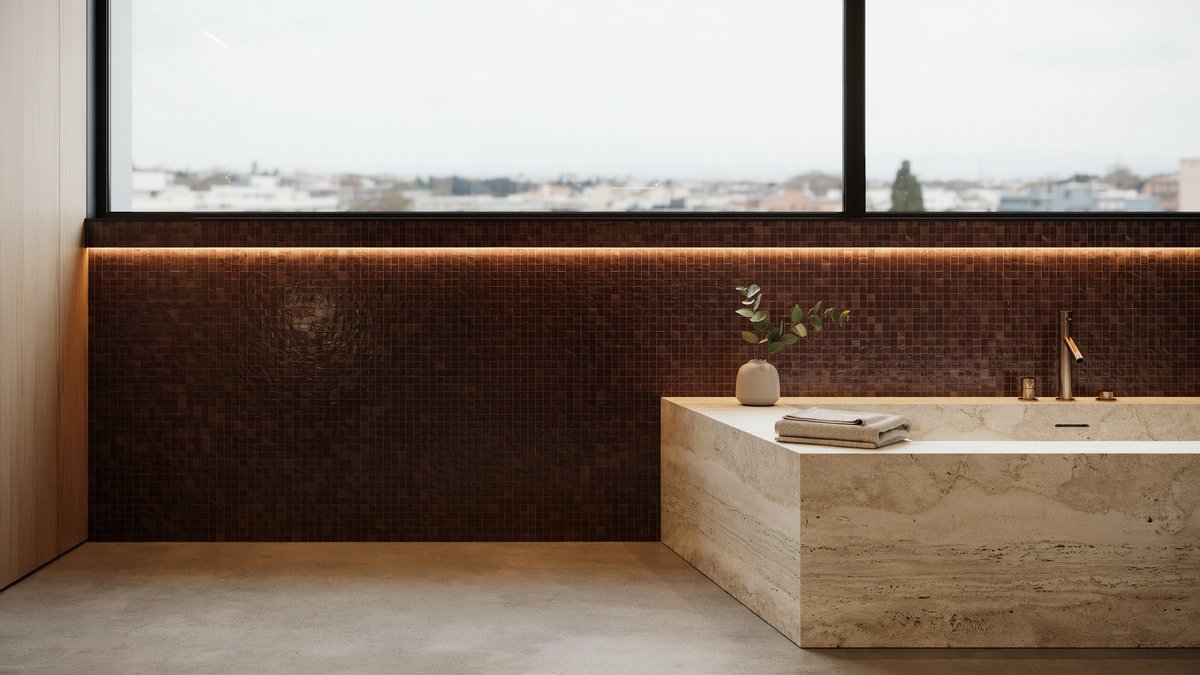 Brown mosaic tiled master bath with a whirlpool tub and travertine surround