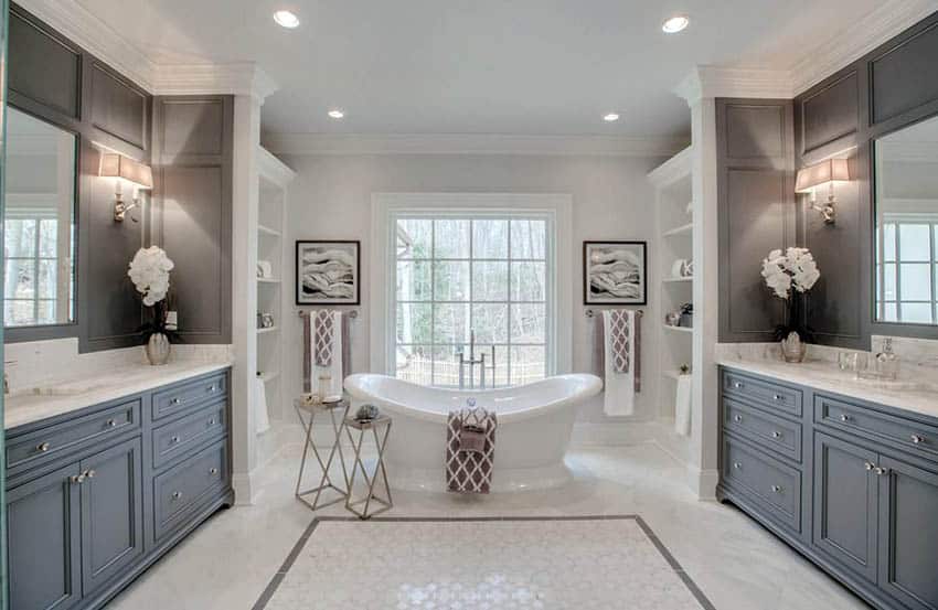Master bathroom with dark gray wall panels, two vanities and freestanding tub