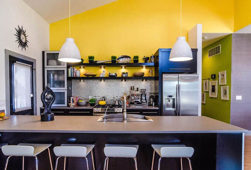 Bright yellow wall matched with black cabinets, wall clocl and stools