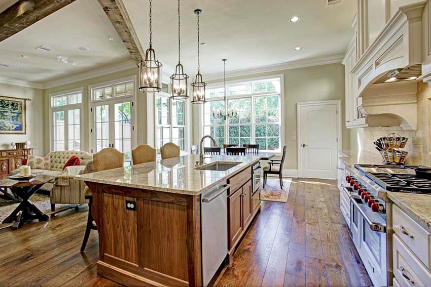 Open concept kitchen with light green paint color and off-white colored cabinets