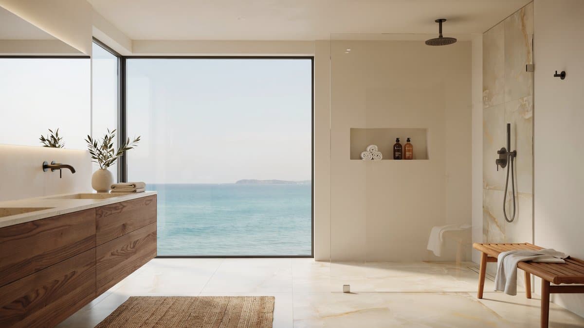 Master bath with a frameless rainfall shower and Sahara Gold marble floor