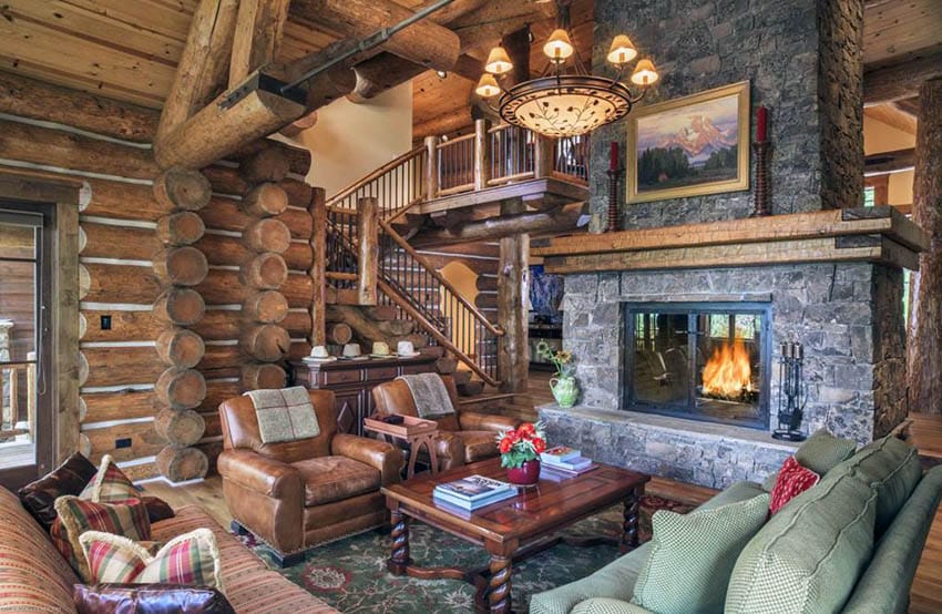 Rustic living room in log cabin home with stone fireplace