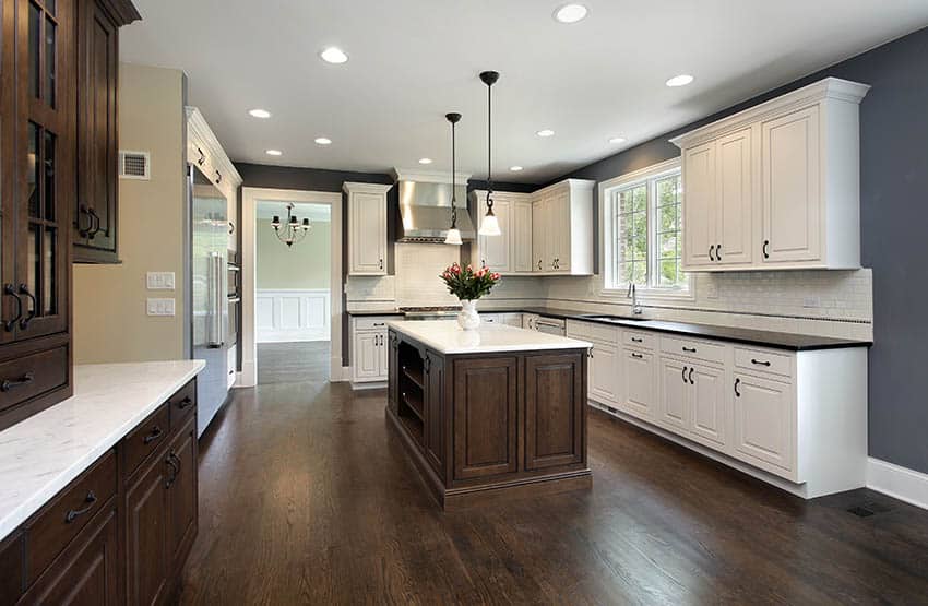 Kitchen with dark wood flooring, recessed lightjing and dark walnut cabinets