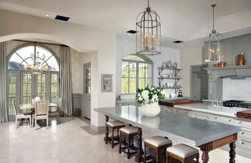 Open plan kitchen with dining room, gray cabinets, porcelain tile floors and concrete island