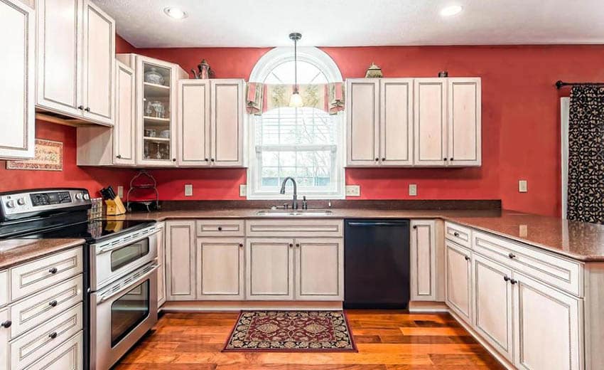 Traditional kitchen with distressed cabinets and ablaze red paint