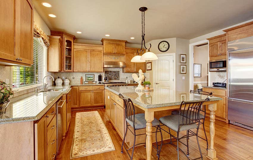 Kitchen with oak wood cabinetry and wall clock