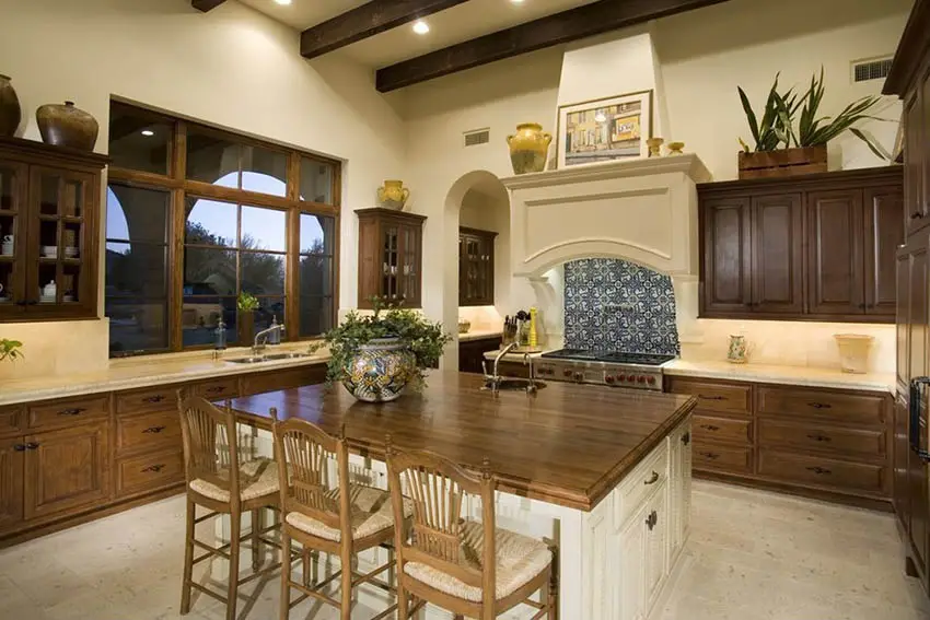 Kitchen with stained raised cabinets and butcher block dining island