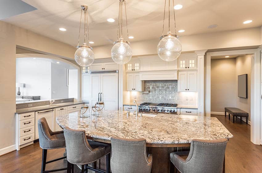 Beige painted kitchen with dark wood island and granite counter