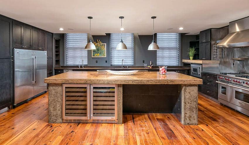 Transitional kitchen with black cabinets and deep tone paint color with wood flooring