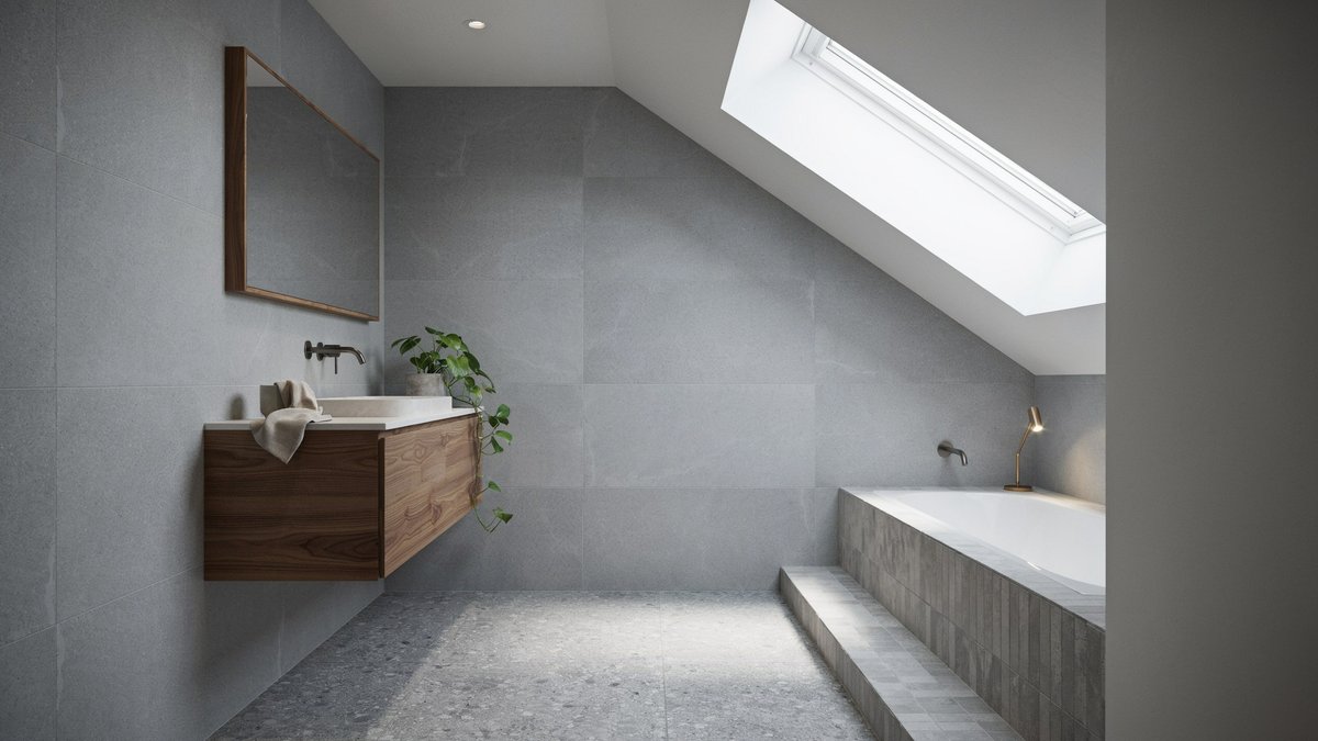 Skylit bathroom with gray tile, a recessed tub, and zebrawood vanity
