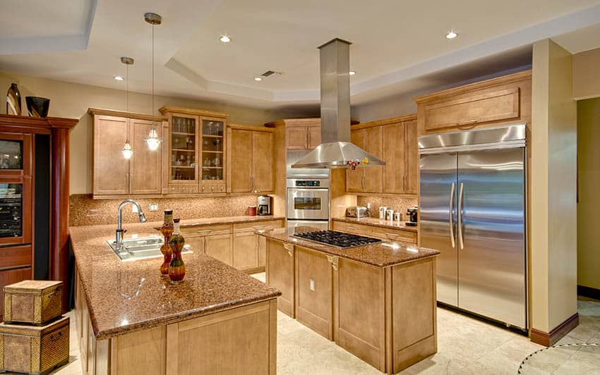 Wood cabinet kitchen with beige painted walls and travertine tile floors