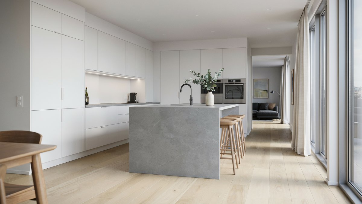 Open-plan kitchen with white cabinets and gray stone-tile countertops